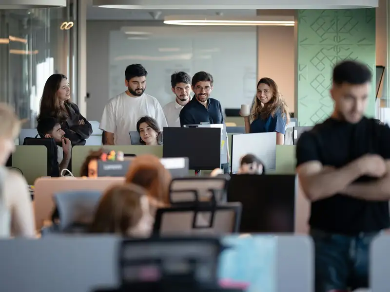 Engineering team members at their workstations in a modern office